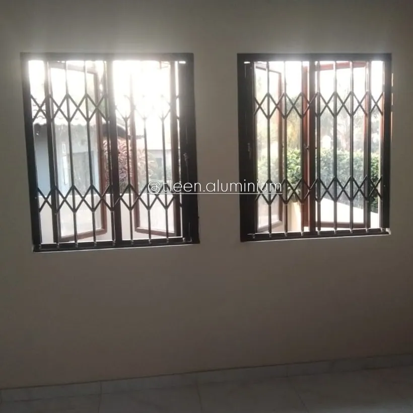 Two windows fitted with matching charcoal trellis guards